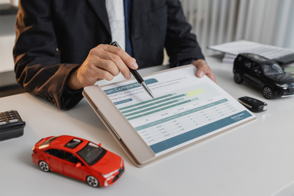 A businessman in a suit is calculating car loan details